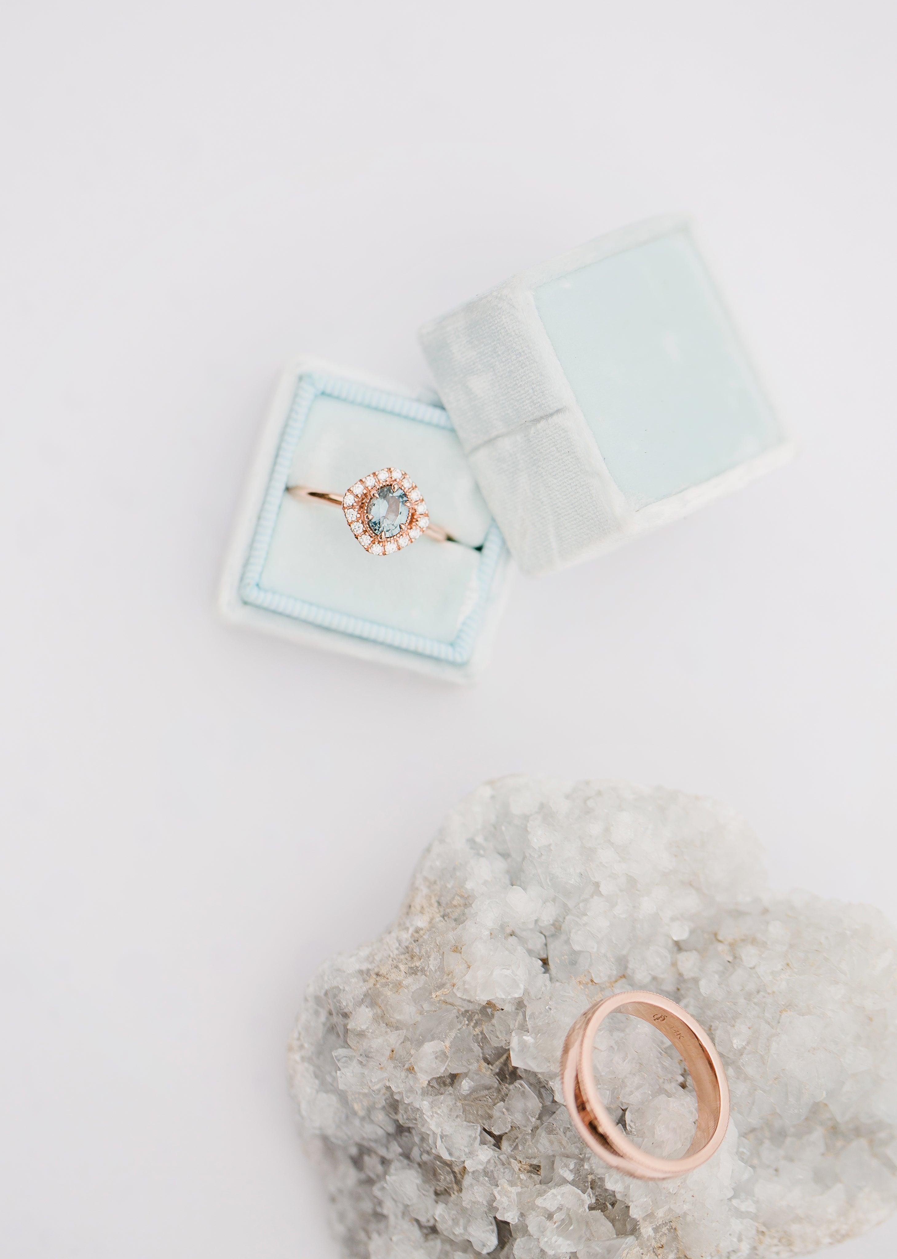 an-engagment-ring-sits-in-a-blue-box.jpg