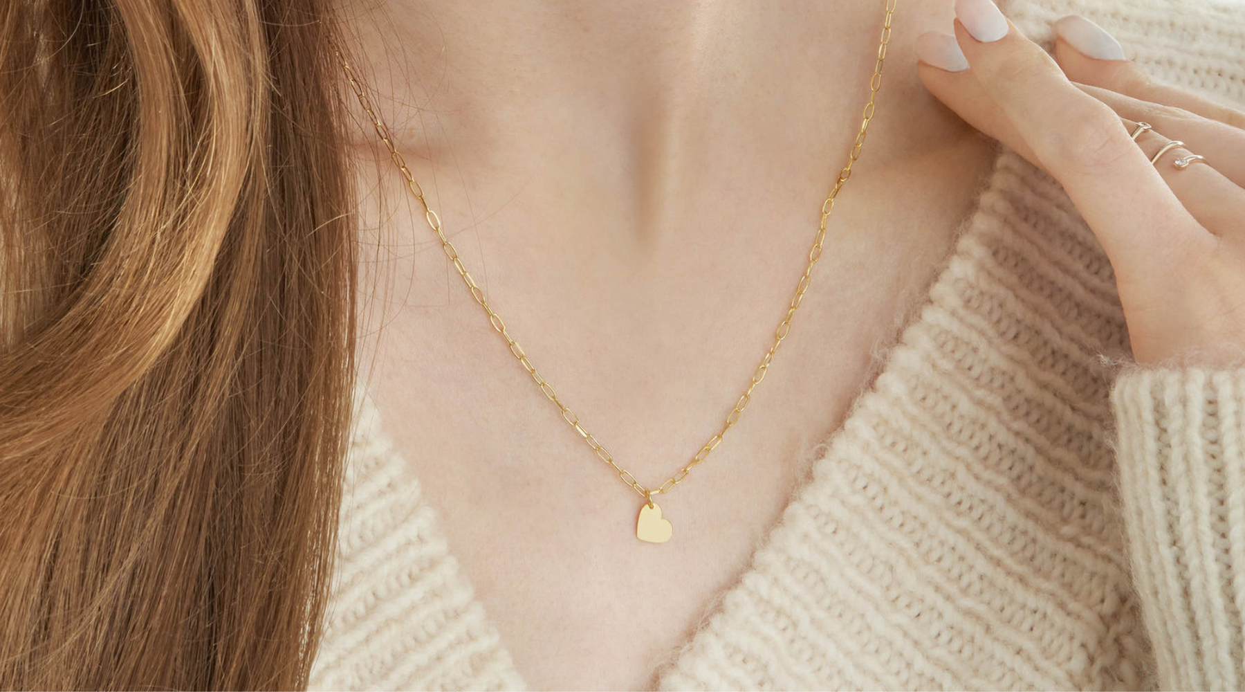Delicate 14K gold heart pendant necklace on model, everyday fine jewelry with chain detail