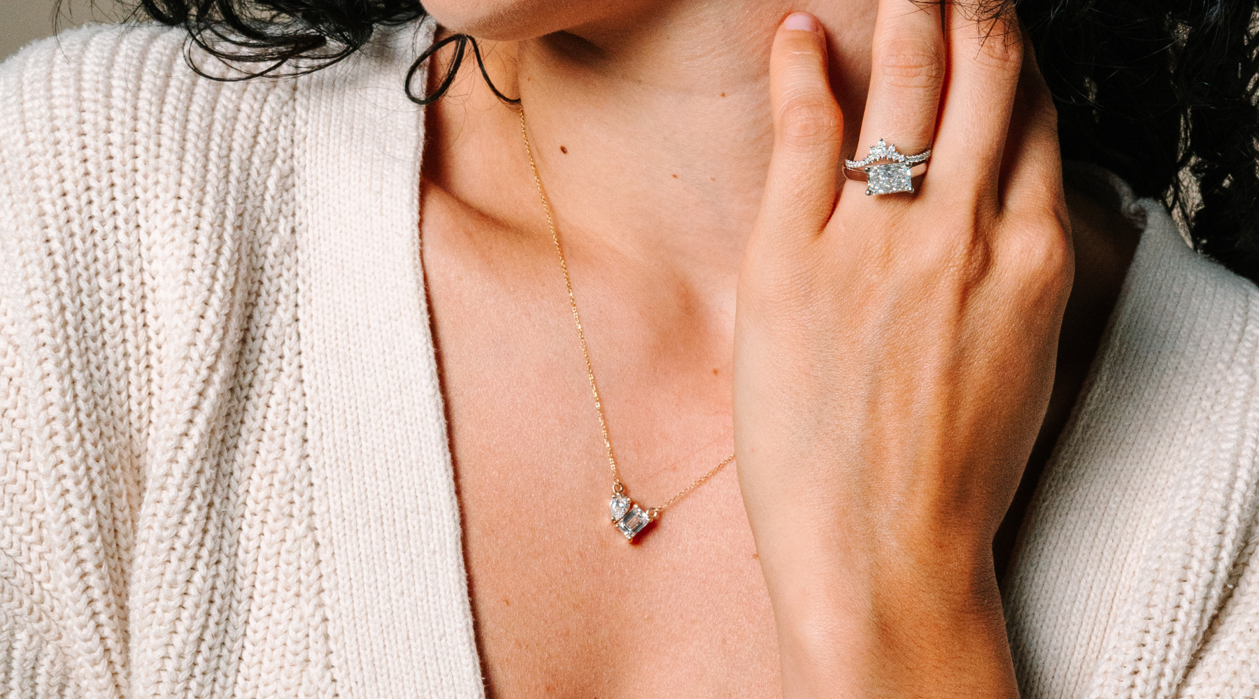 Woman wearing 14K gold diamond necklace and ring, elegant fine jewelry for everyday wear