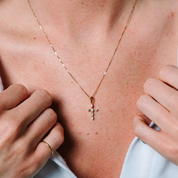 14K gold diamond cross necklace on woman's chest, delicate chain with sparkling stones, everyday fine jewelry