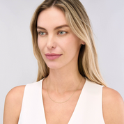 Woman wearing delicate 14K gold chain necklace, timeless fine jewelry for everyday wear
