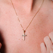 14K gold cross necklace with diamond accents, worn close-up on skin for everyday elegance