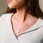 Delicate 14K gold necklace with white clover pendant, perfect for everyday wear and timeless elegance.