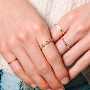 14K gold diamond rings on hands, featuring delicate chain and baguette designs for everyday wear