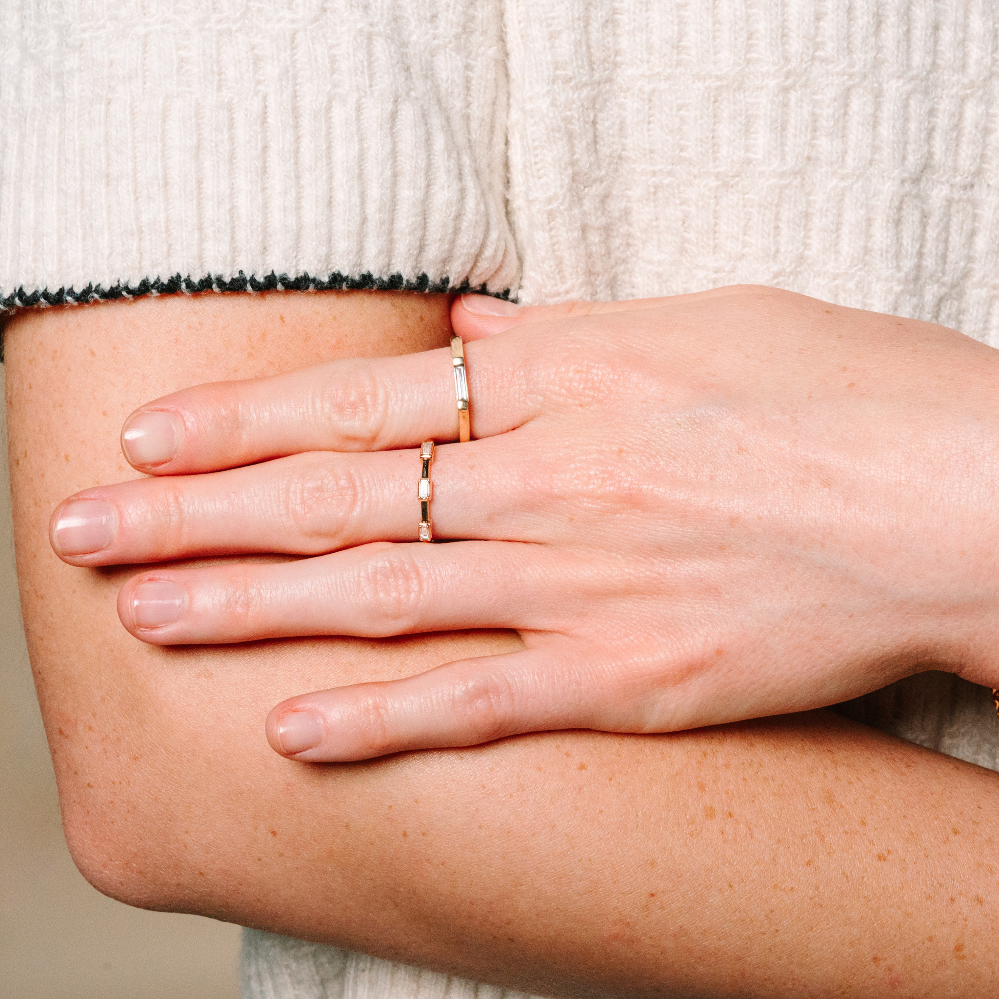 14K gold diamond stackable rings on woman's hand, everyday fine jewelry