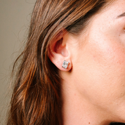 Woman wearing radiant cut diamond stud earring in 14K gold, elegant everyday fine jewelry