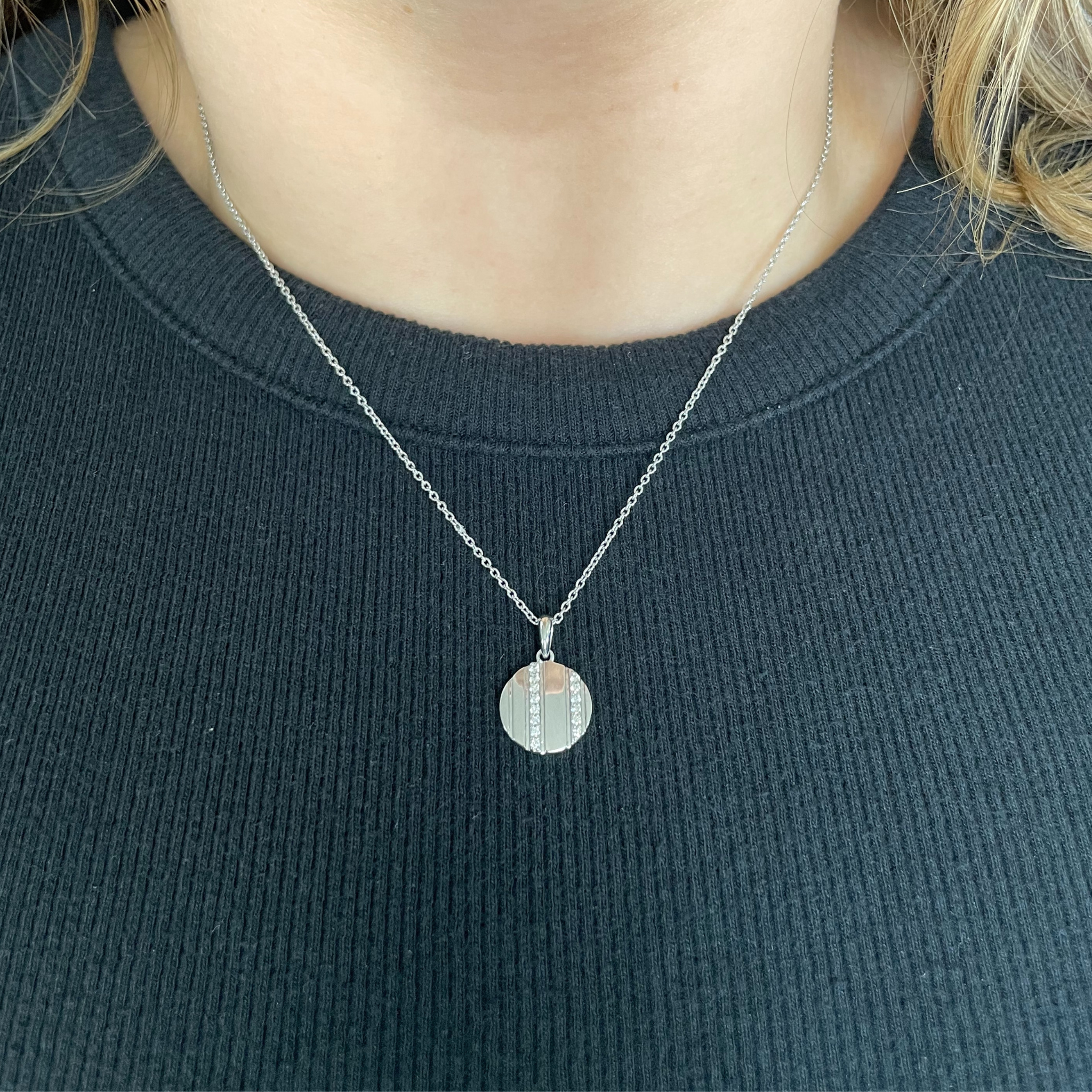 Round diamond stripe pendant necklace in 14K gold, worn on chain with dark ribbed top