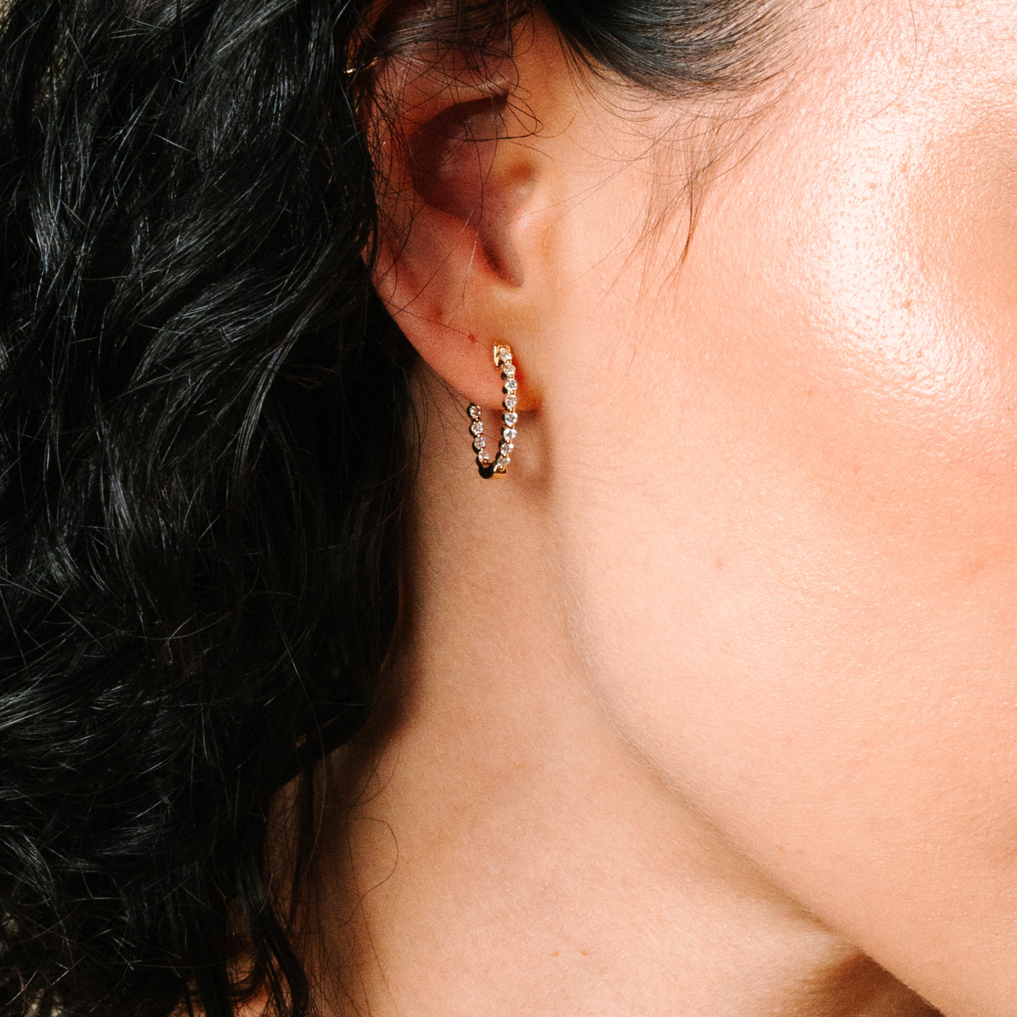 14K gold hoop earring with diamonds, worn on ear, timeless fine jewelry for everyday wear
