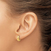 14K gold huggie hoop earring on ear, minimalist fine jewelry for everyday wear