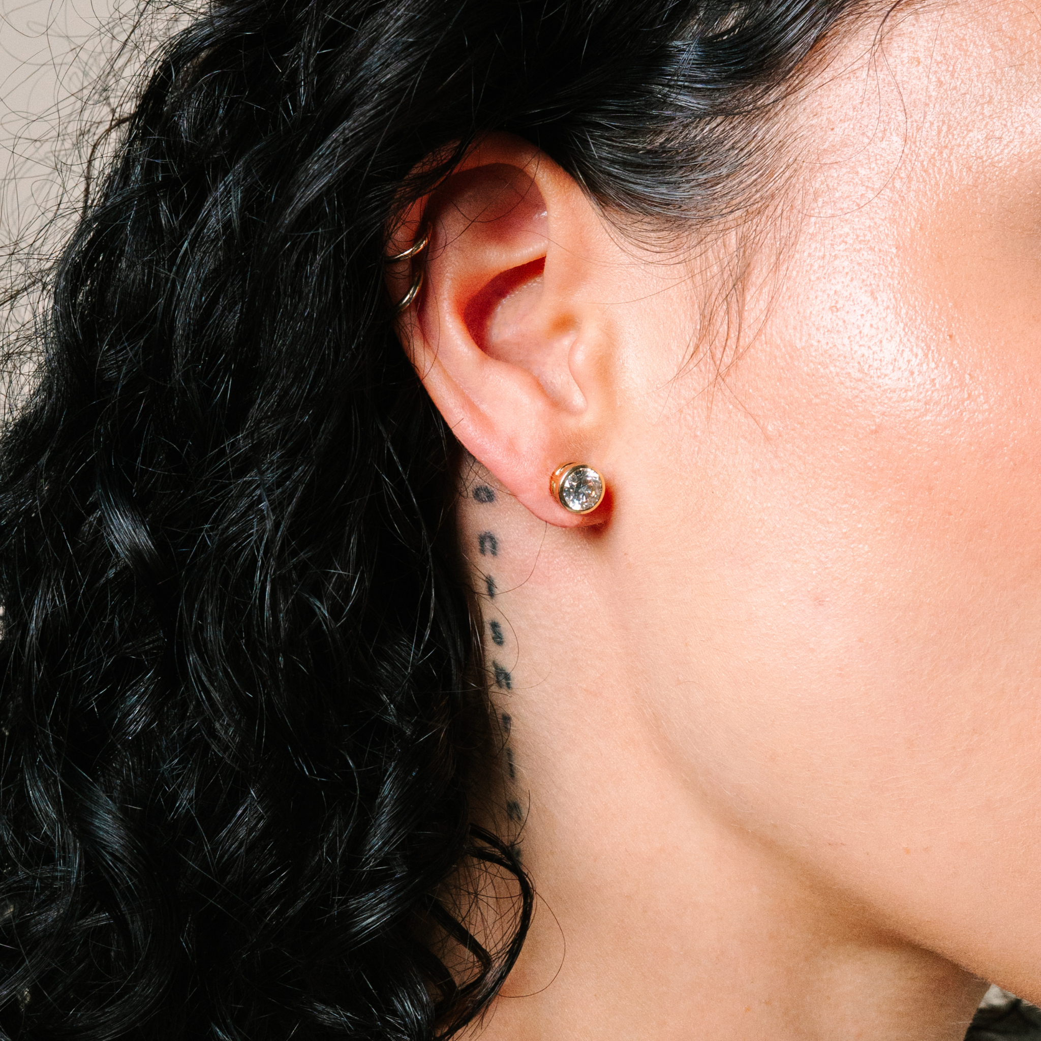14K gold diamond stud earring on ear, everyday fine jewelry for women