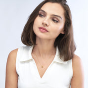 Woman wearing 14K gold knot necklace, timeless fine jewelry for everyday wear