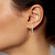 Diamond hoop earring in 14K gold, worn on ear, timeless fine jewelry for everyday elegance