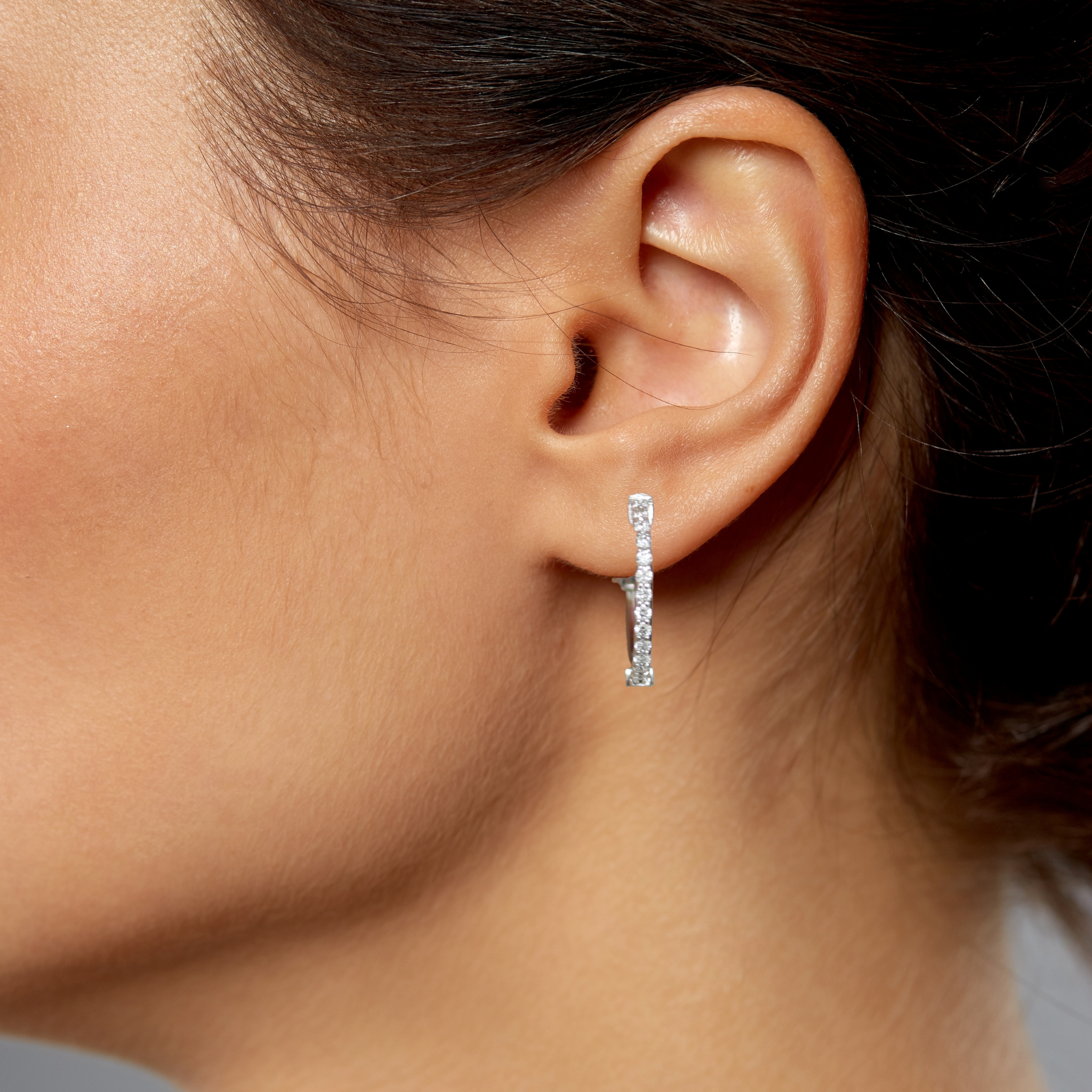 Diamond hoop earring in 14K gold, worn on ear, timeless fine jewelry for everyday wear