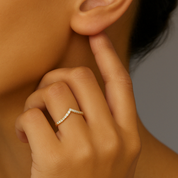 14K gold chevron ring with diamonds, worn on finger near ear, timeless fine jewelry