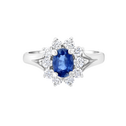 Elegant sapphire and diamond ring in 14K white gold, featuring oval blue sapphire center with halo of round diamonds.