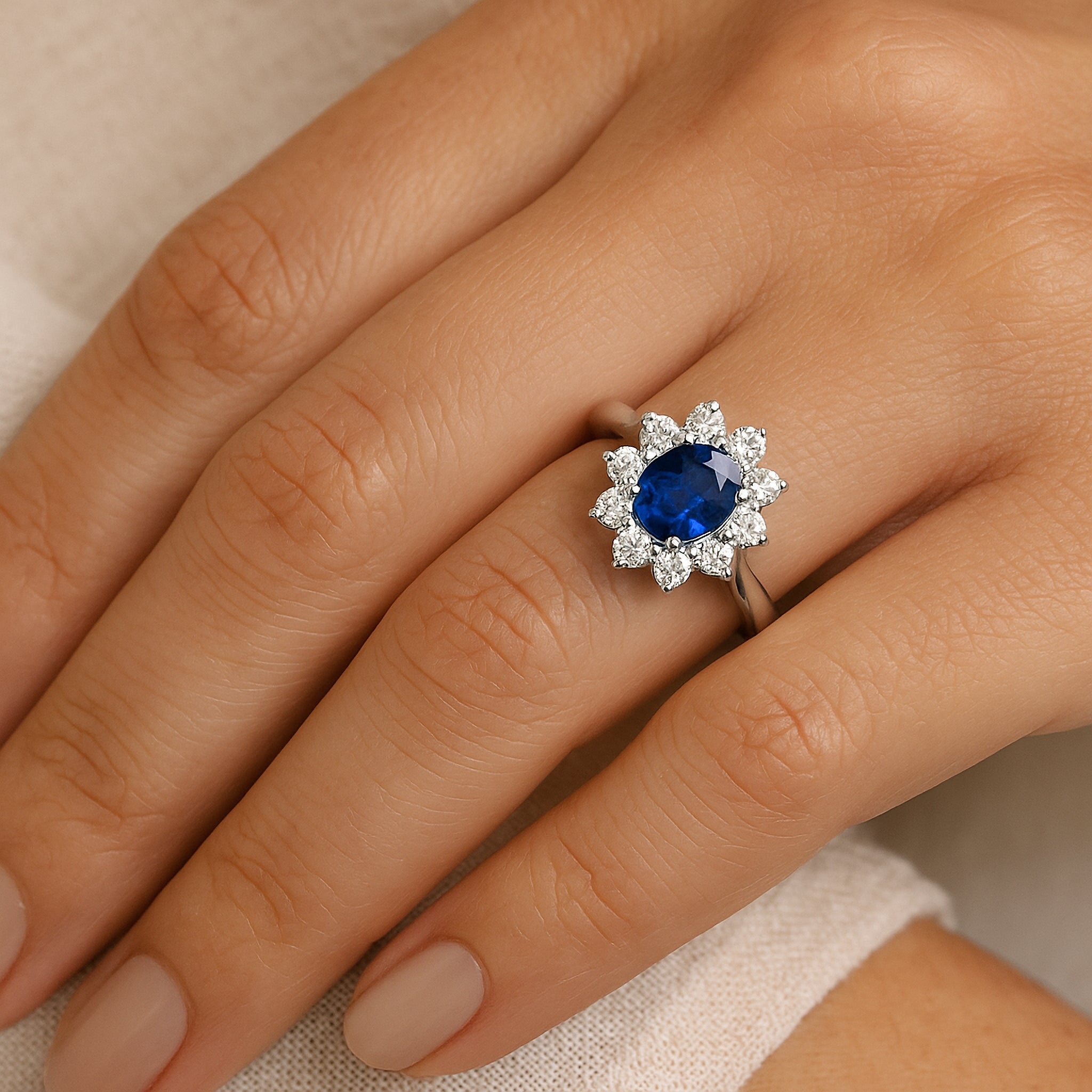 Elegant sapphire and diamond halo ring in 14K gold, worn on hand for timeless fine jewelry look