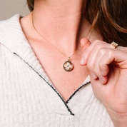 14K gold diamond flower pendant necklace with matching ring, worn elegantly on model