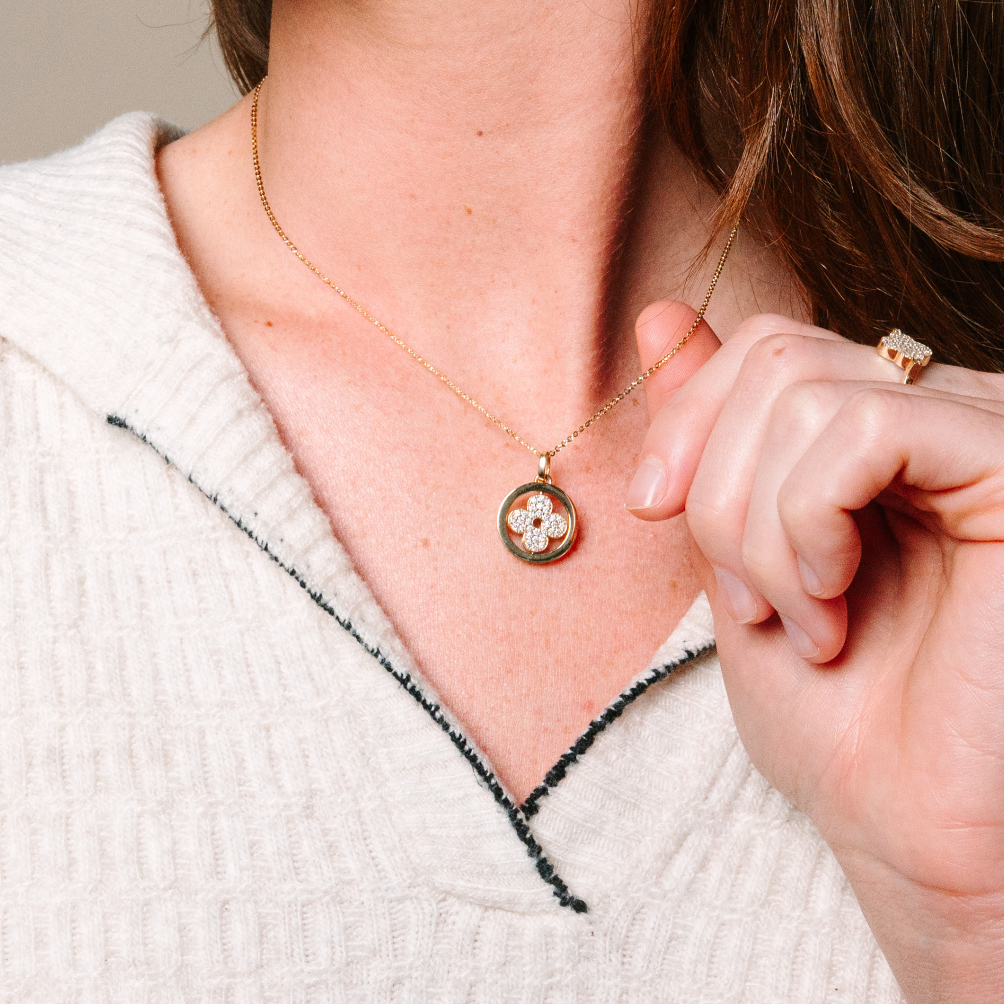 14K gold diamond flower pendant necklace with matching ring, worn elegantly on model
