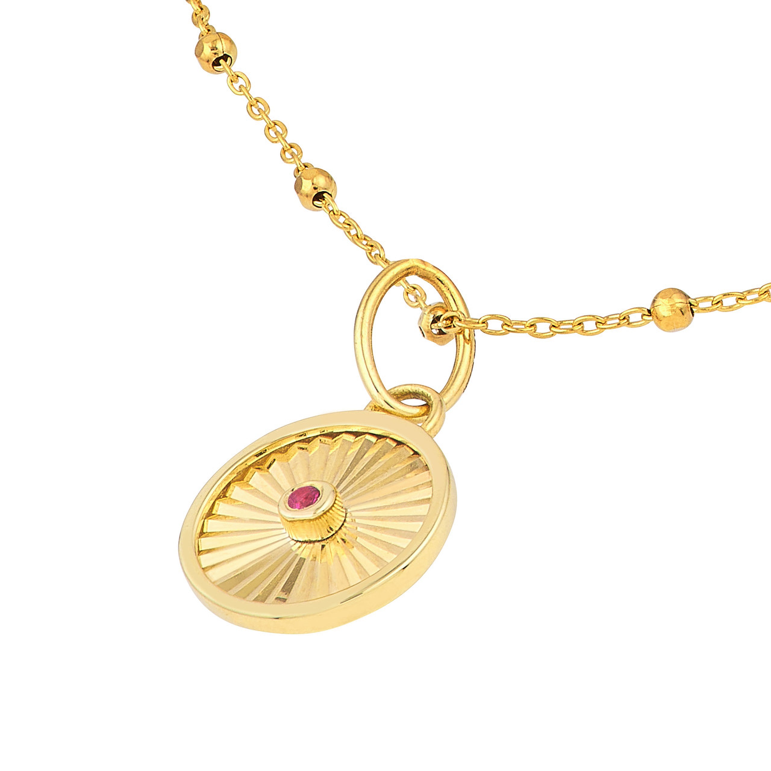 14K gold necklace with sunburst pendant and ruby center, featuring textured chain and bead accents