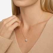 14K gold diamond solitaire necklace on woman, delicate chain with round pendant, everyday fine jewelry