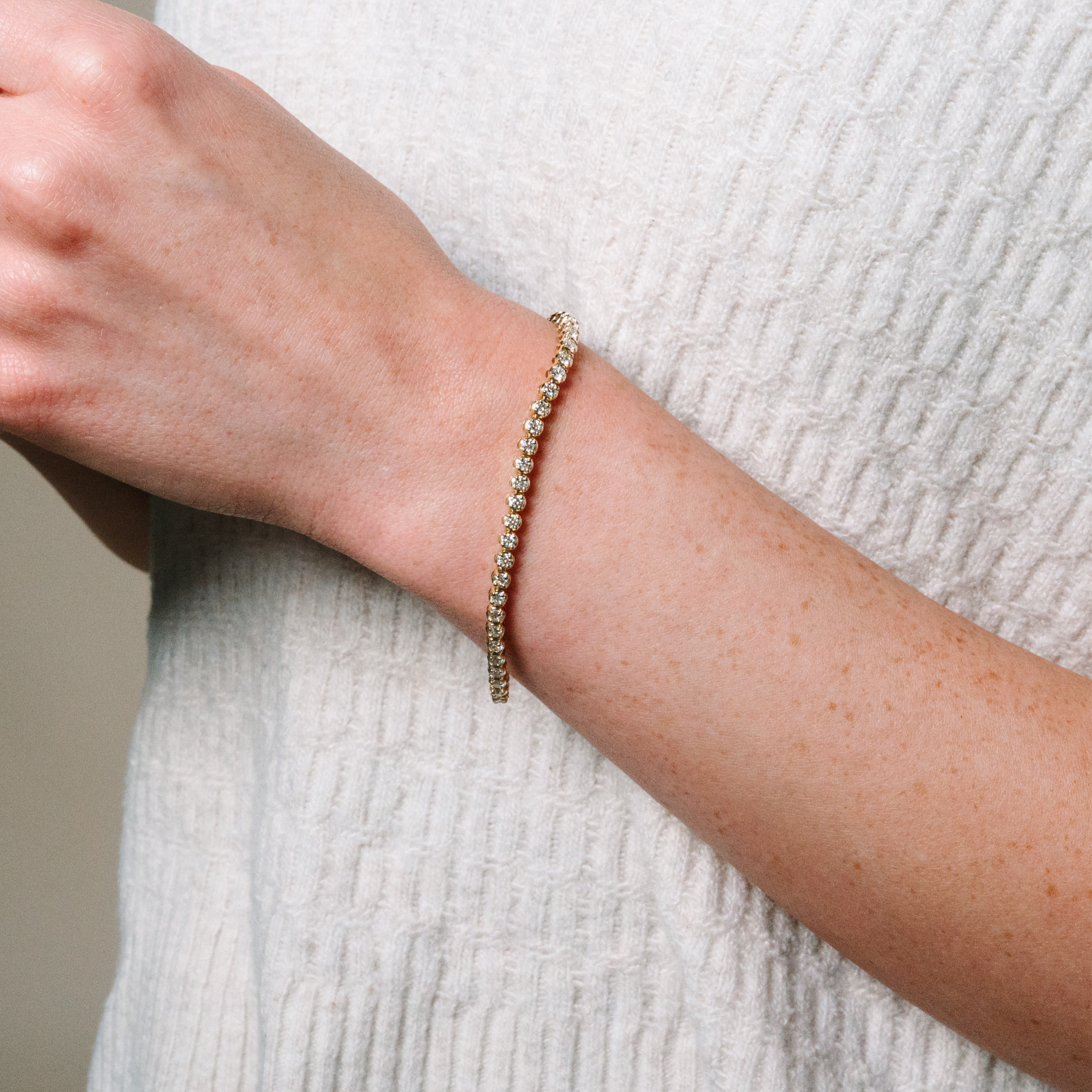 14K gold diamond tennis bracelet on wrist, timeless fine jewelry for everyday wear