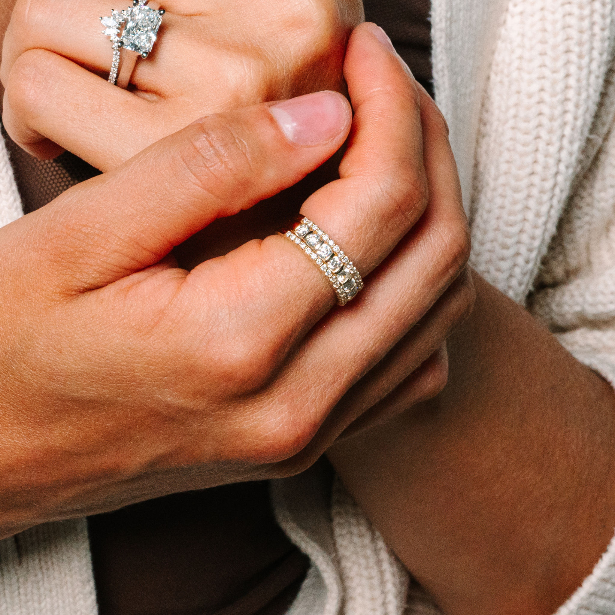 Elegant diamond rings in 14K gold, featuring a radiant cut engagement ring and a stacked band design.