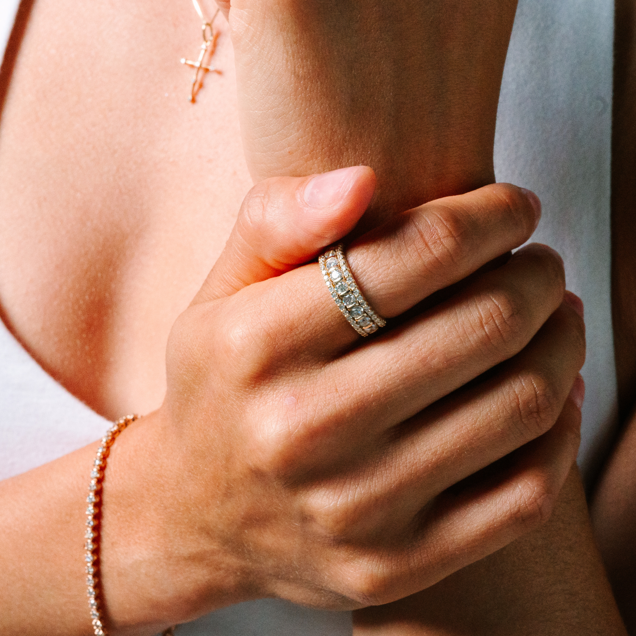 14K gold diamond stackable rings on hand with matching necklace and bracelet, timeless fine jewelry