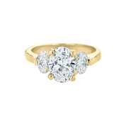 14K yellow gold three-stone diamond ring with oval center and side stones, timeless fine jewelry
